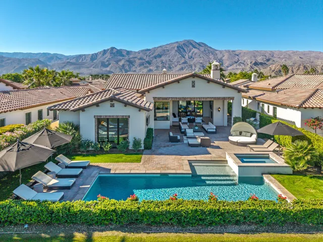a swimming pool with outdoor seating and yard