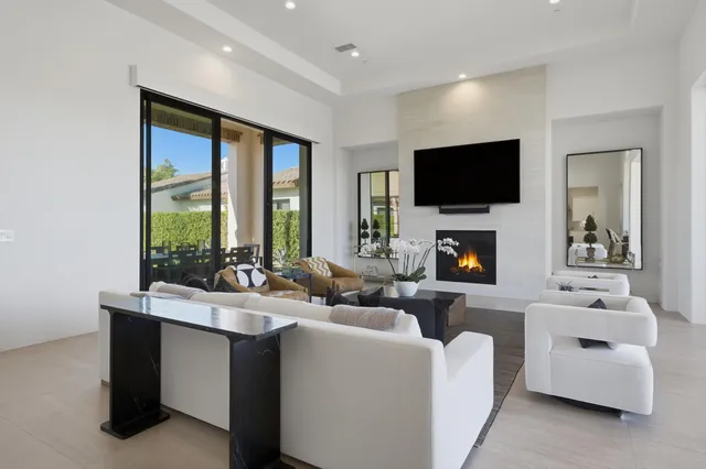 a kitchen with a dining table chairs stainless steel appliances and cabinets