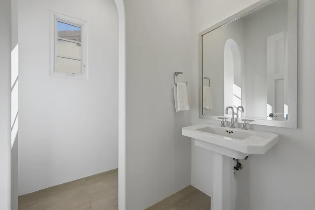 a bedroom with a bed and a flat tv screen on the dresser