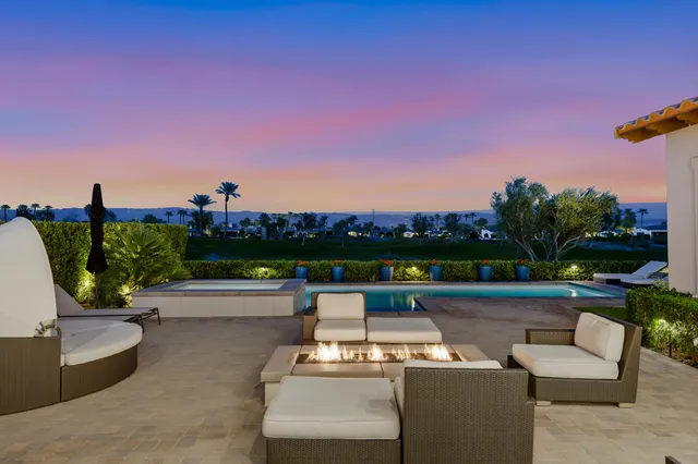 a view of a patio with couches and a table and chairs
