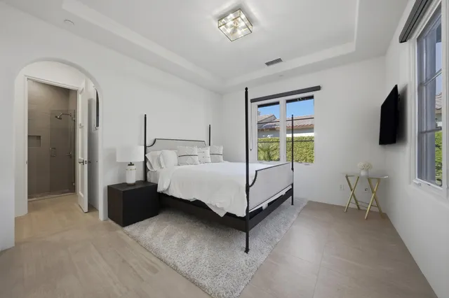 a living room with furniture and a floor to ceiling window