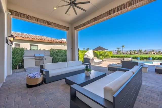 a view of a house with big yard and potted plants
