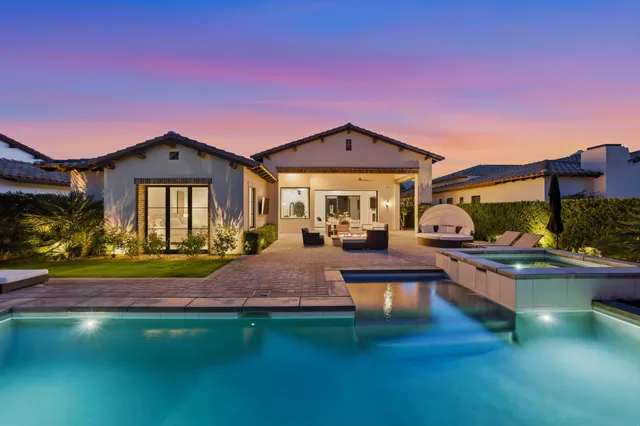 a view of a chairs and table in patio with a lake view