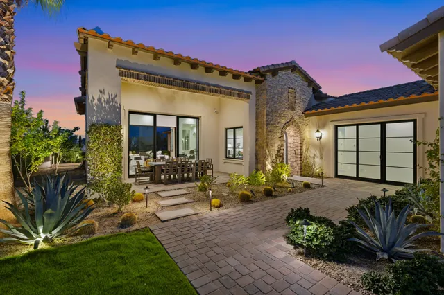a front view of a house with a yard table and chairs