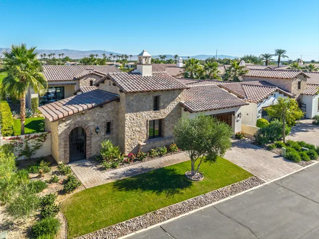 a view of a lake with couches and table and chairs under an umbrella