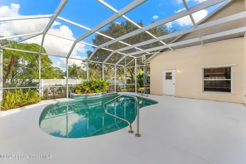 a view of an empty room with wooden floor and closet