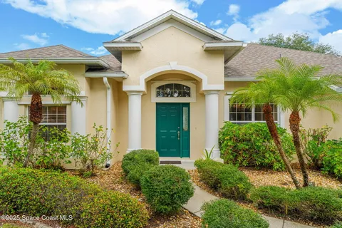 a front view of house with yard and green space