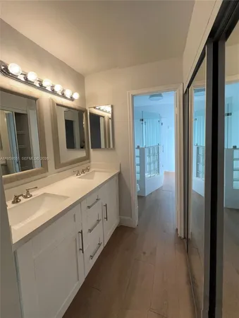 a spacious bathroom with a double vanity sink and a mirror