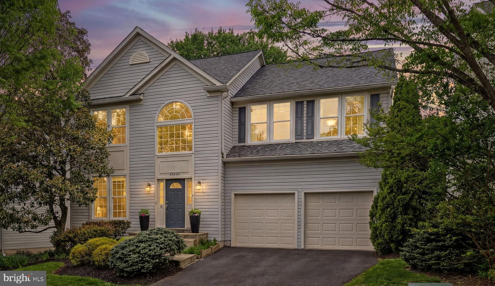 43200 Lighthouse Place Chantilly, VA 20152 - Photo 1 of 47 a front view of a house with a yard and garage