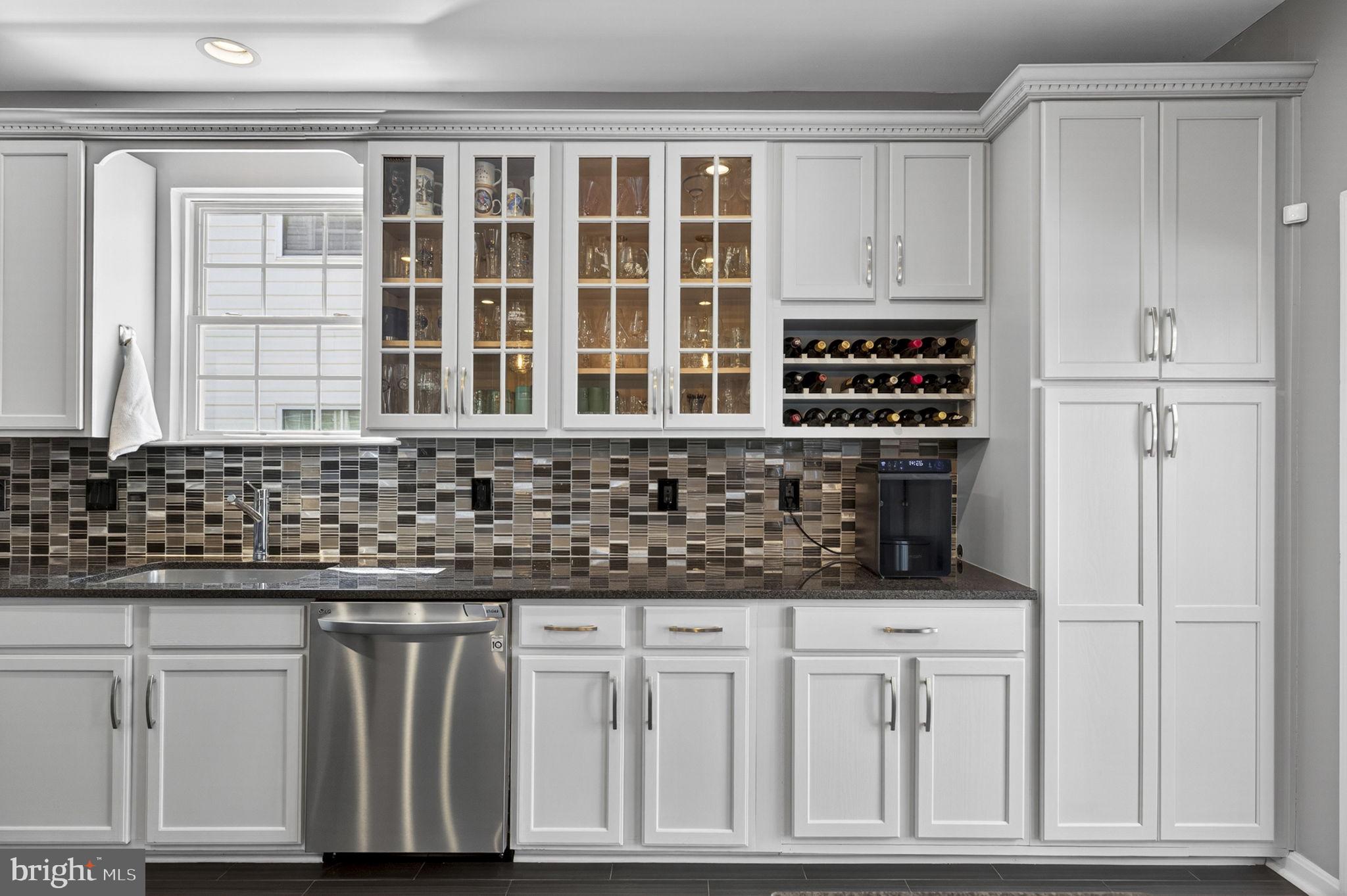 43200 Lighthouse Place Chantilly, VA 20152 - Photo 16 of 47 a kitchen with granite countertop white cabinets and window