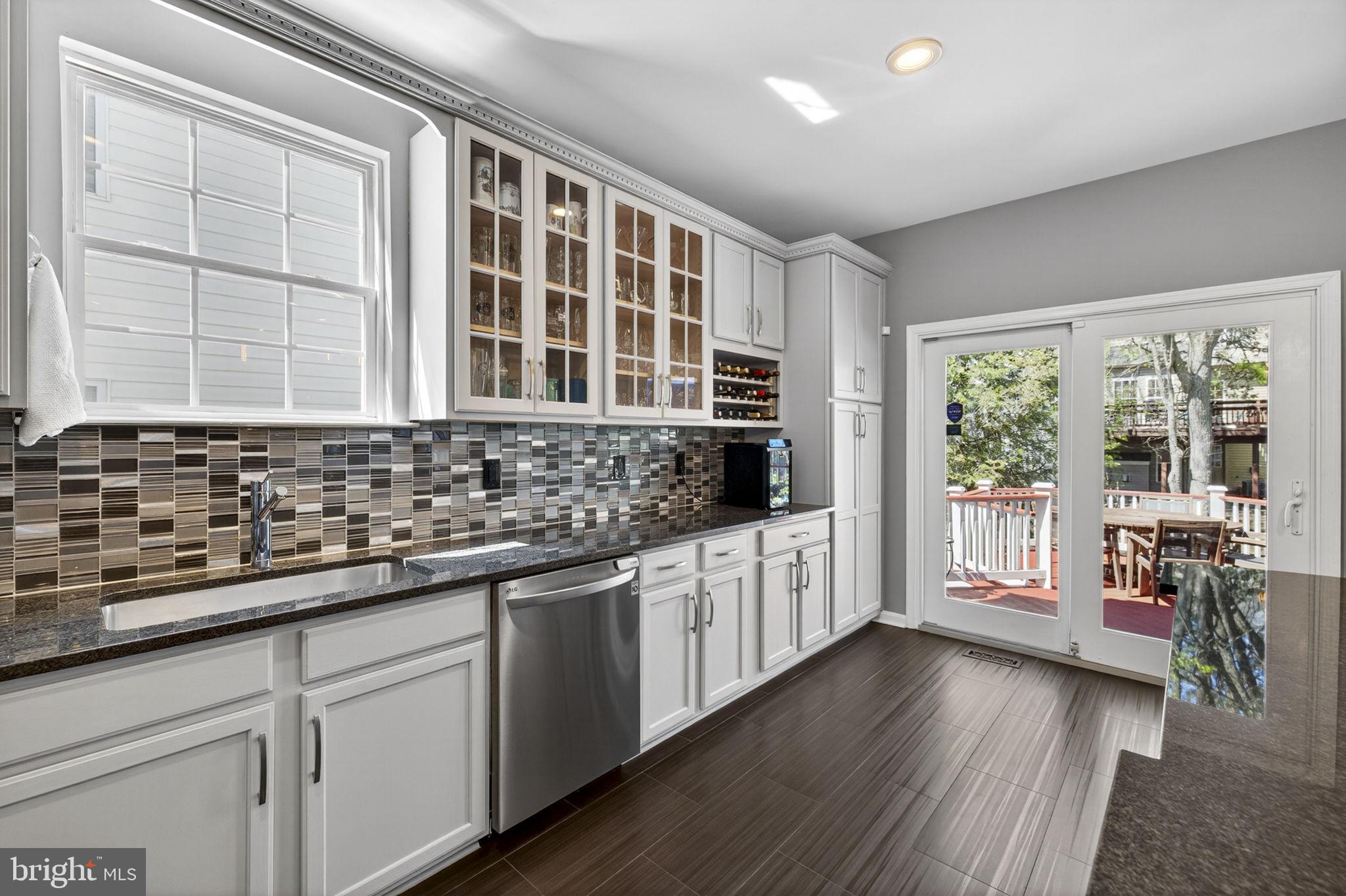 43200 Lighthouse Place Chantilly, VA 20152 - Photo 17 of 47 a kitchen with granite countertop a stove a sink and wooden floors