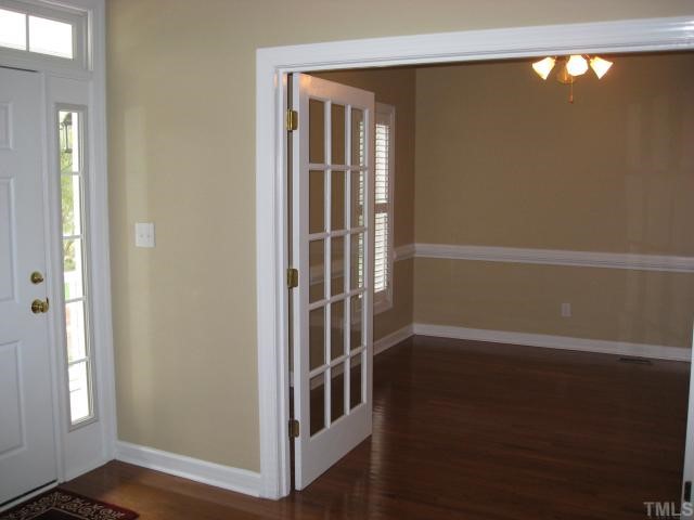 2912 Candlehurst Lane Raleigh, NC 27616 - Photo 2 of 12 a view of hallway with stairs and wooden floor
