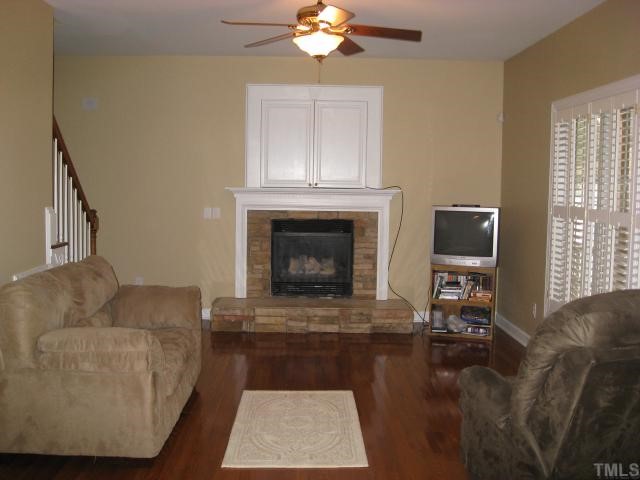 2912 Candlehurst Lane Raleigh, NC 27616 - Photo 4 of 12 a living room with furniture and a fireplace