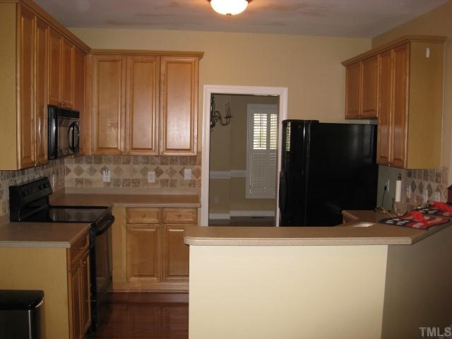 2912 Candlehurst Lane Raleigh, NC 27616 - Photo 5 of 12 a kitchen with stainless steel appliances granite countertop cabinets and refrigerator