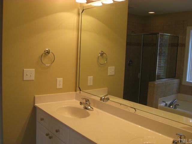 2912 Candlehurst Lane Raleigh, NC 27616 - Photo 8 of 12 a bathroom with a granite countertop sink and a mirror