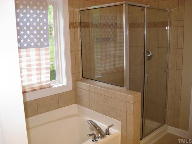 2912 Candlehurst Lane Raleigh, NC 27616 - Photo 9 of 12 a bathroom with a bathtub and shower
