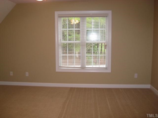 2912 Candlehurst Lane Raleigh, NC 27616 - Photo 10 of 12 a view of a room with wooden floor and windows