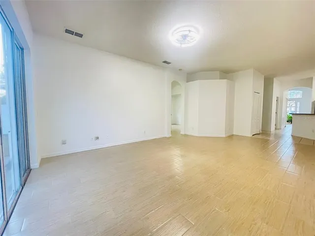 an empty room with a empty space and windows