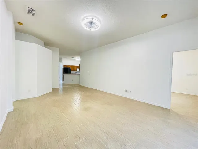 a kitchen with stainless steel appliances a sink a stove and a refrigerator with wooden floor