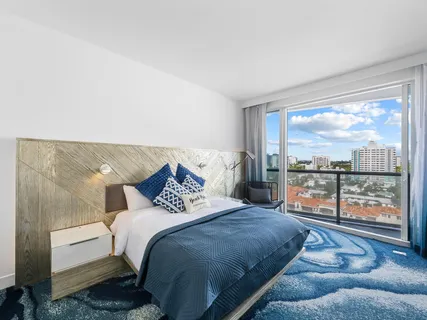 a bedroom with a bed and glass window