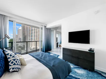 a bedroom with a bed and glass window