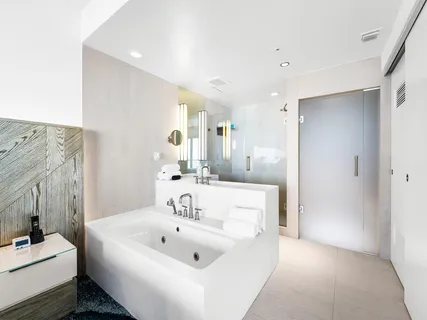 a en suite bathroom with a sink a tub and a mirror