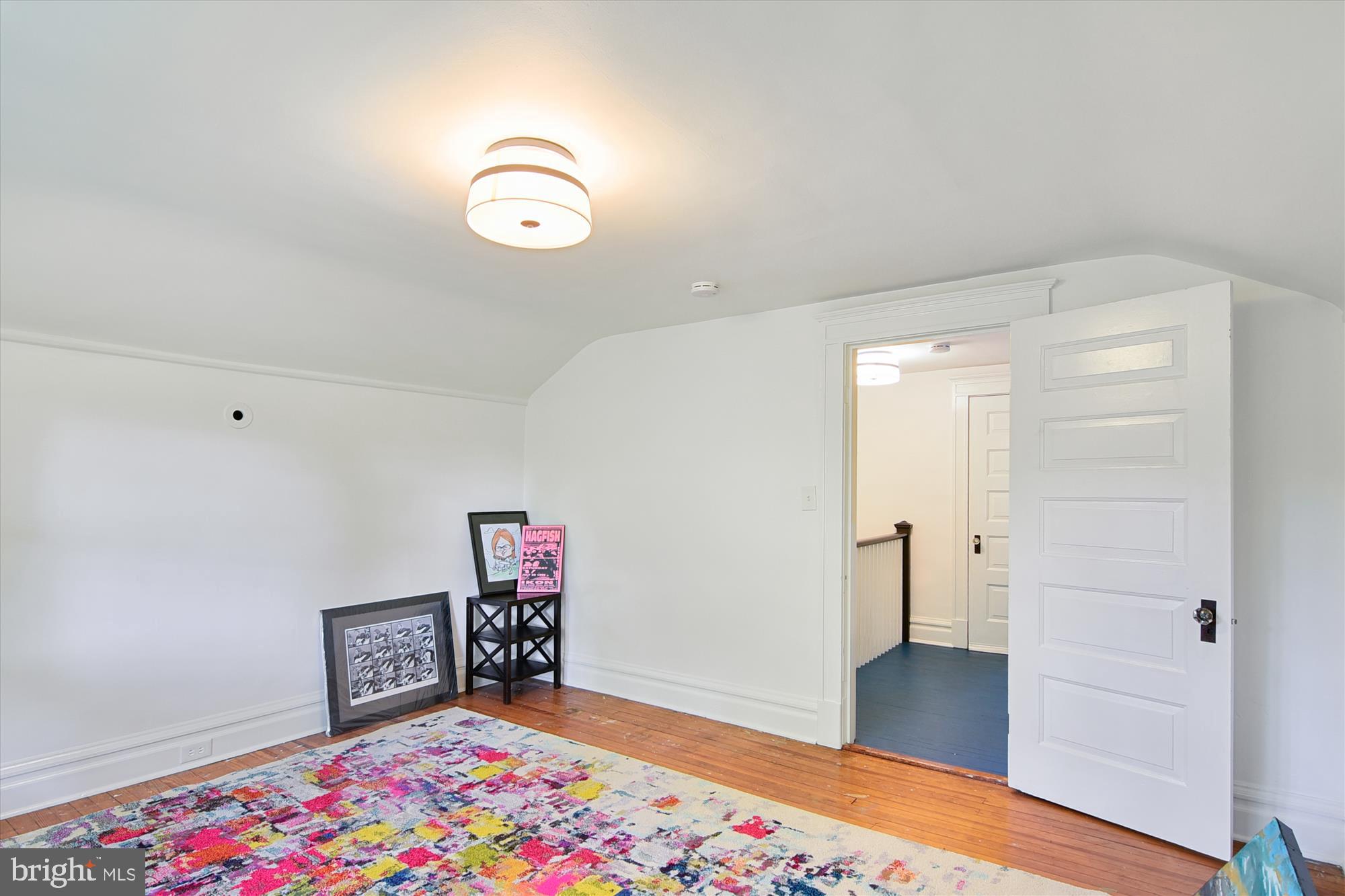 208 Edgevale Road Baltimore, MD 21210 - Photo 46 of 69 a view of an empty room with wooden floor and a window