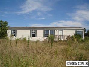 a view of house with backyard and garden
