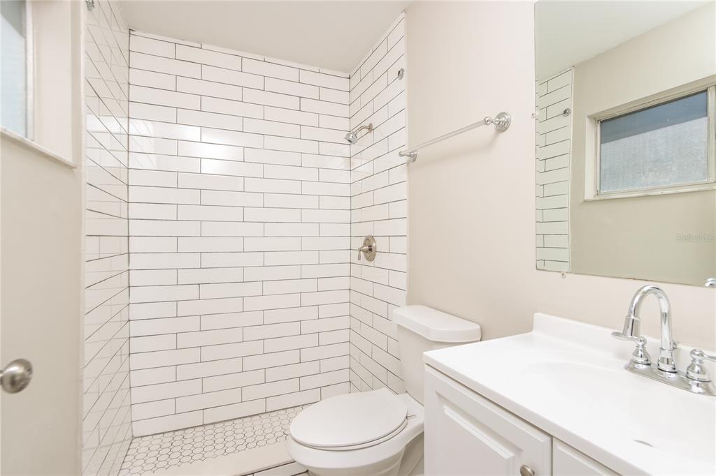 481 Ralwood Lane Northeast Palm Bay, FL 32907 - Photo 13 of 18 a bathroom with a sink a toilet and shower