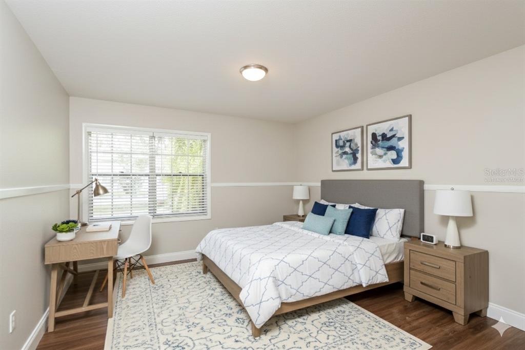 481 Ralwood Lane Northeast Palm Bay, FL 32907 - Photo 15 of 18 a bedroom with a bed and wooden floor