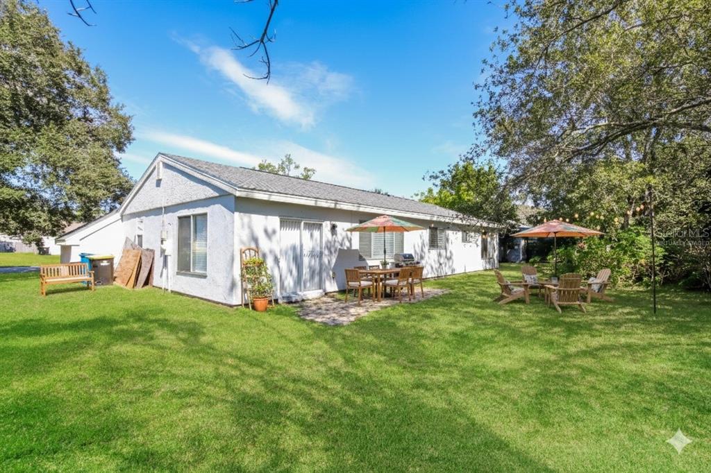481 Ralwood Lane Northeast Palm Bay, FL 32907 - Photo 18 of 18 a view of a house with backyard sitting area and garden