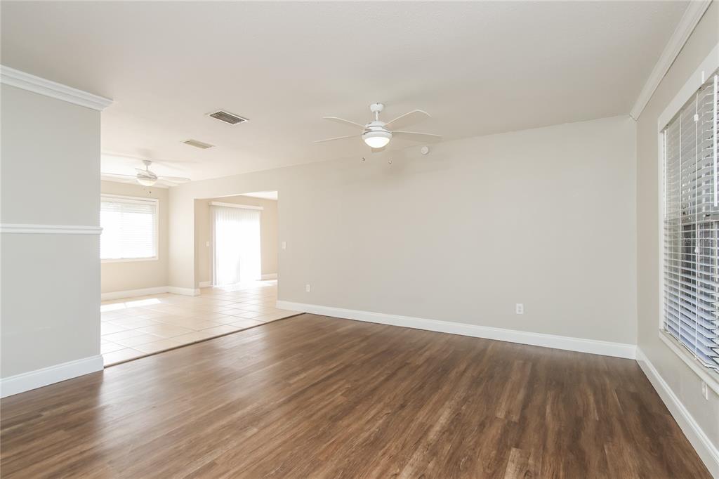 481 Ralwood Lane Northeast Palm Bay, FL 32907 - Photo 3 of 18 an empty room with wooden floor and windows