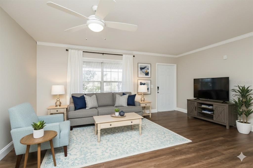 481 Ralwood Lane Northeast Palm Bay, FL 32907 - Photo 5 of 18 a living room with furniture and a flat screen tv
