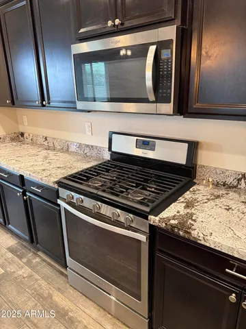 a stove top oven sitting inside of a kitchen