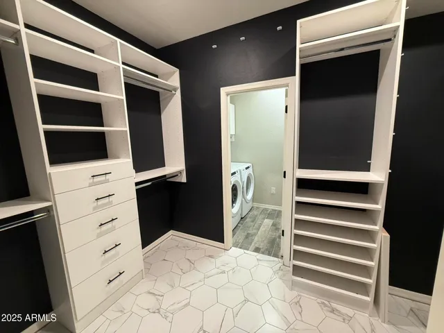 a view of closet with wooden floor