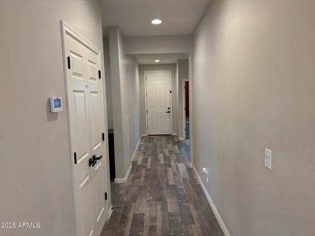 a view of an empty room and wooden floor