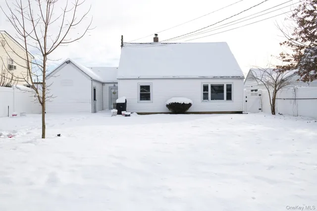 a view of the house with a snow on the road