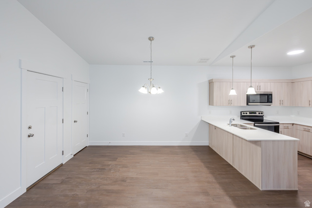 4661 Poplar Way, Unit R302 Mapleton, UT 84664 - Photo 13 of 17 Kitchen featuring a peninsula, light wood finish cabinetry, stainless steel appliances, and dark wood-style flooring