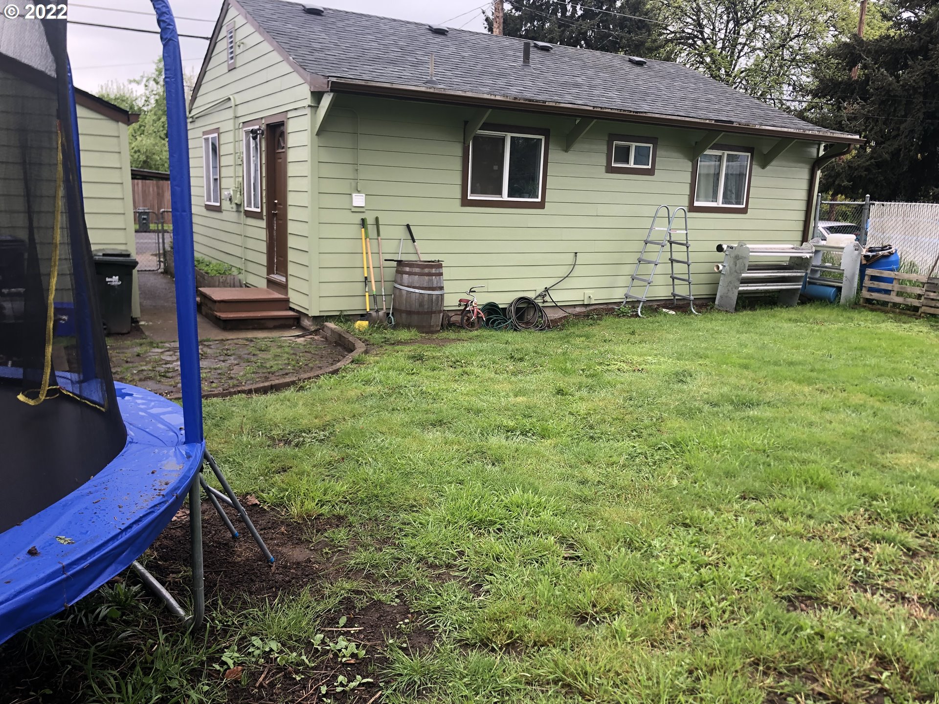 2796 J Street Springfield, OR 97477 - Photo 18 of 18 a view of a backyard with couches plants and large tree