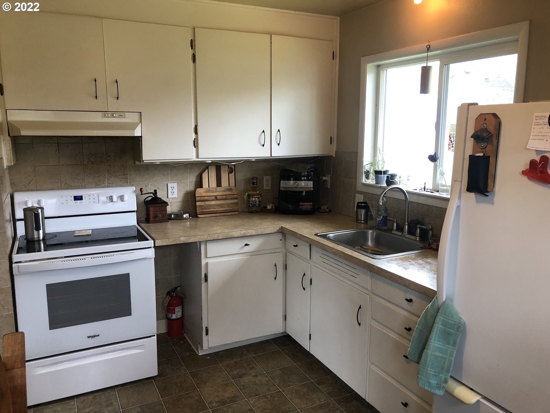2796 J Street Springfield, OR 97477 - Photo 9 of 18 a kitchen with granite countertop white cabinets and white appliances