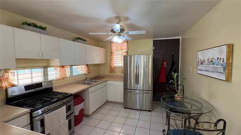 1 St Rio Grande, Unit B6 Rio Grande, PR 00745 - Photo 36 of 47 a kitchen with stainless steel appliances a stove a refrigerator and cabinets