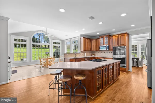 a dining room with furniture a chandelier and outdoor view
