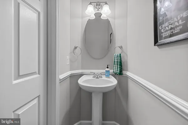 a bathroom with a granite countertop sink a toilet and a large mirror