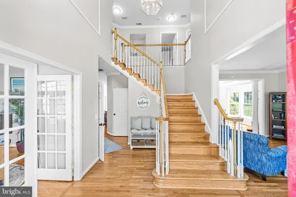 a view of staircase with lots of frames and wooden floor
