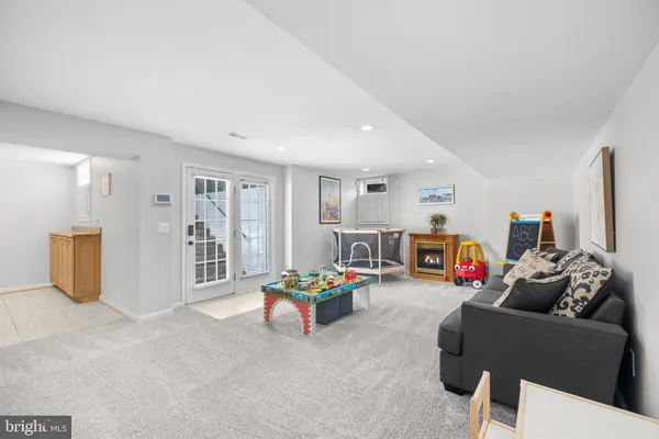 a dining room with furniture a flat screen tv and a floor to ceiling window