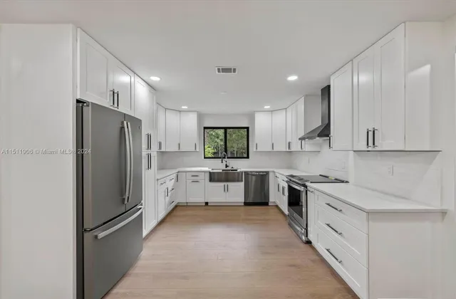 a large kitchen with cabinets and stainless steel appliances