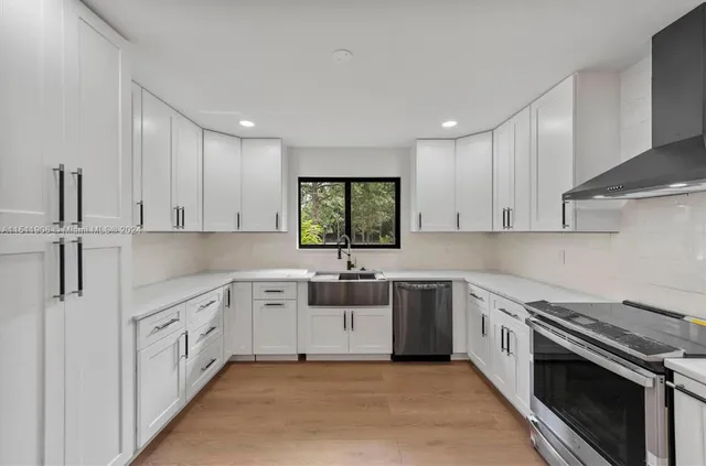 a kitchen with a sink stove and cabinets