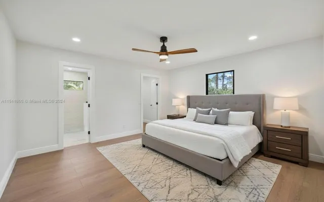 a bedroom with a bed and a ceiling fan