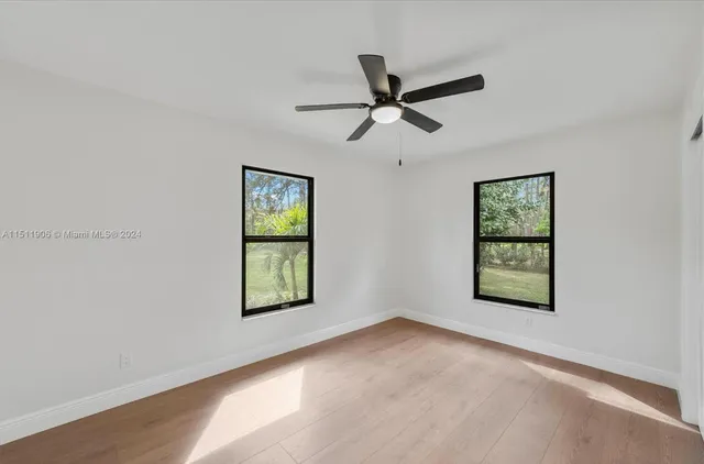 a view of a big room with windows and closet