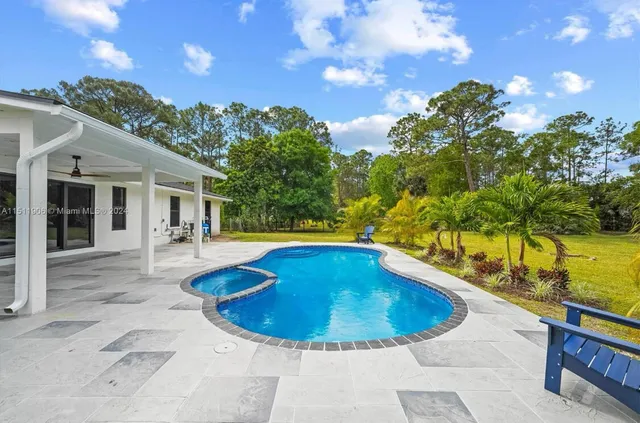 a view of swimming pool with seating space